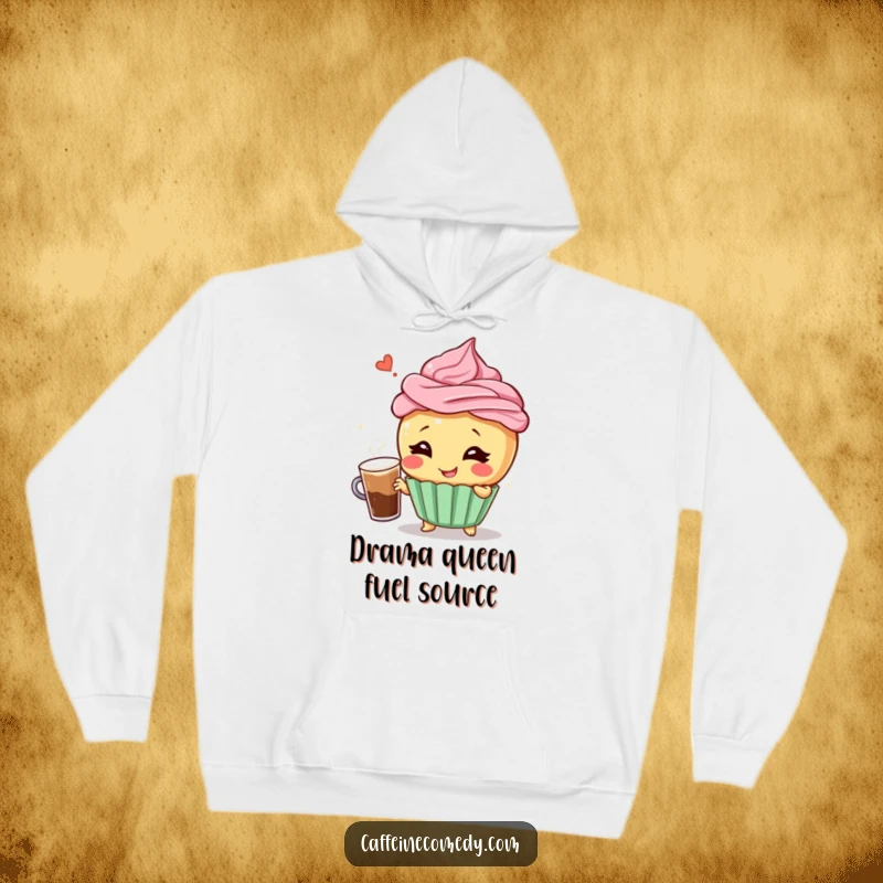 Funny hoodie showcasing a giggling cupcake character posing dramatically with a frothy coffee, offering warmth and humorous cheer.