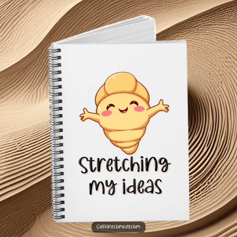 Funny happy croissant character stretching its flaky arms, on the cover of a humorous notebook for jotting down cozy thoughts.